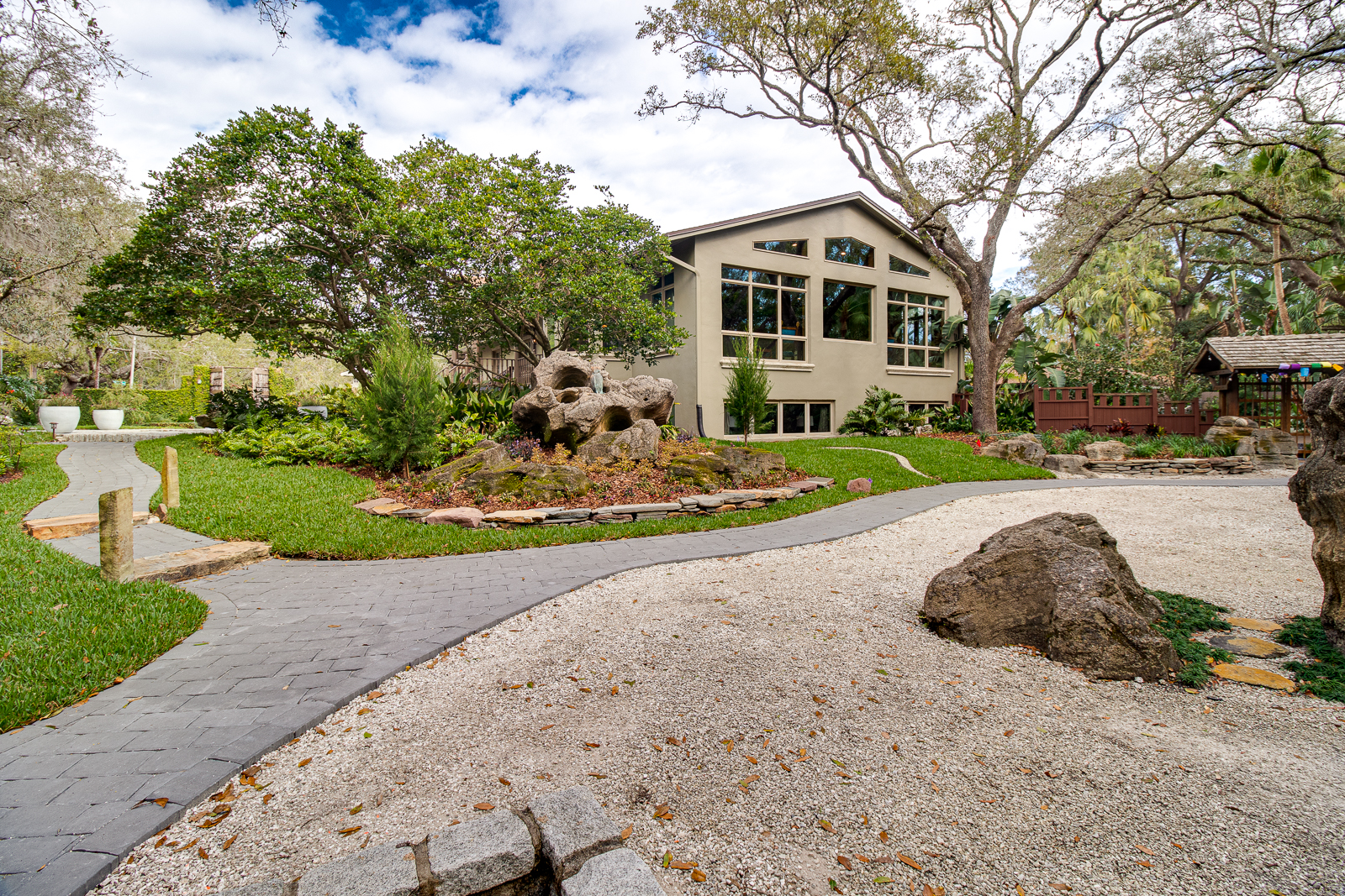 Stone garden path winding through the grounds toward the house