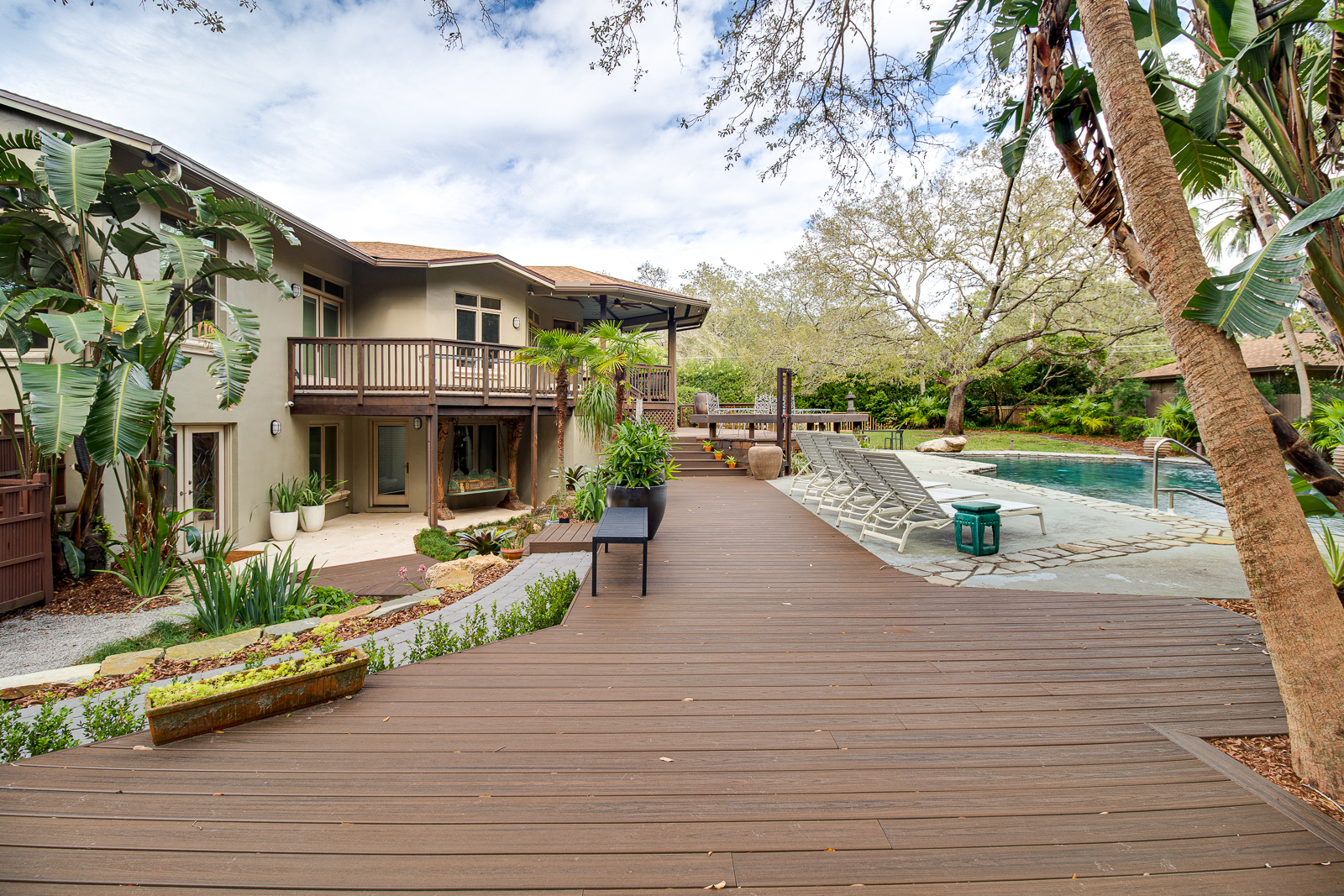 Wooden walkway leading past the gardens to the pool
